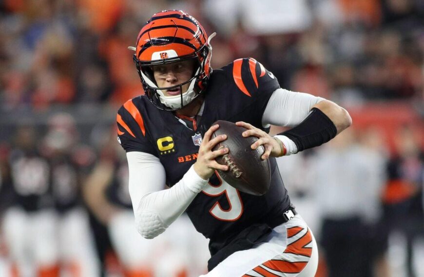 Cincinnati Bengals quarterback Joe Burrow runs with the ball during a play.