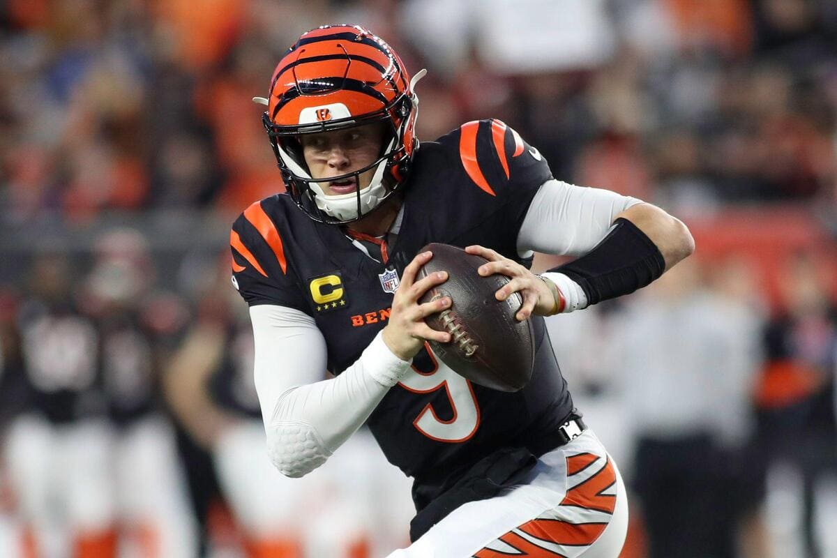 Cincinnati Bengals quarterback Joe Burrow runs with the ball during a play.