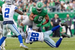 Philadelphia Eagles running back Saquon Barkley hurdles a defender.