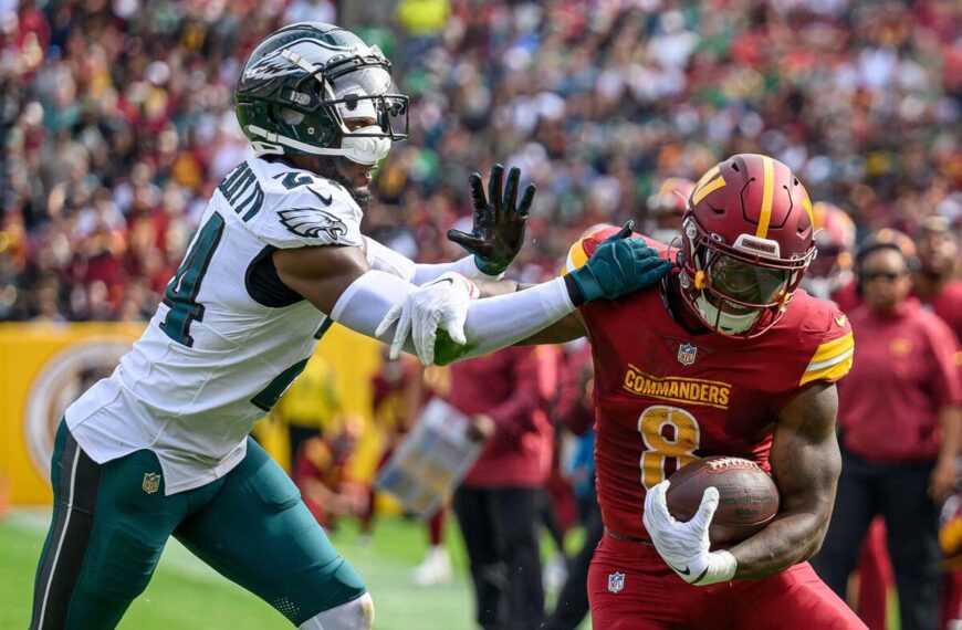 Washington Commanders running back Brian Robinson Jr. tries to avoid being tackled by Philadelphia Eagles cornerback James Bradberry