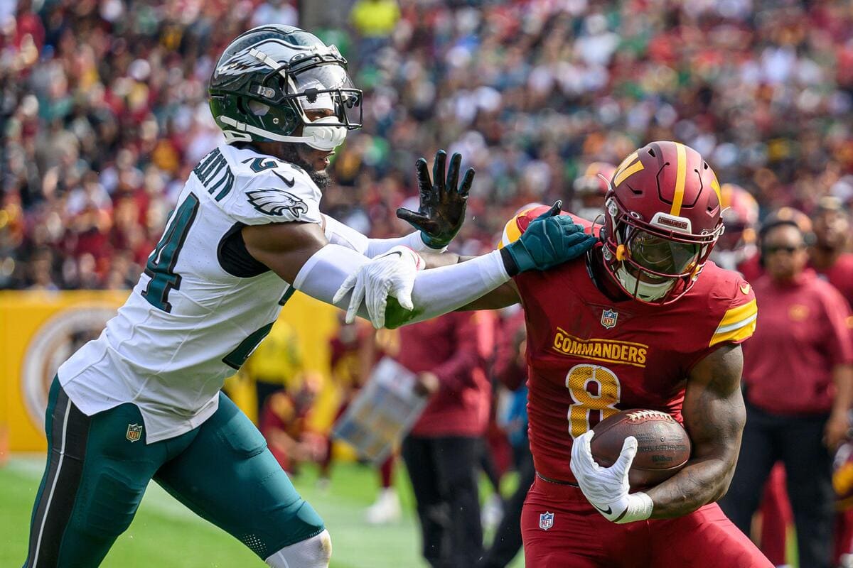 Washington Commanders running back Brian Robinson Jr. tries to avoid being tackled by Philadelphia Eagles cornerback James Bradberry