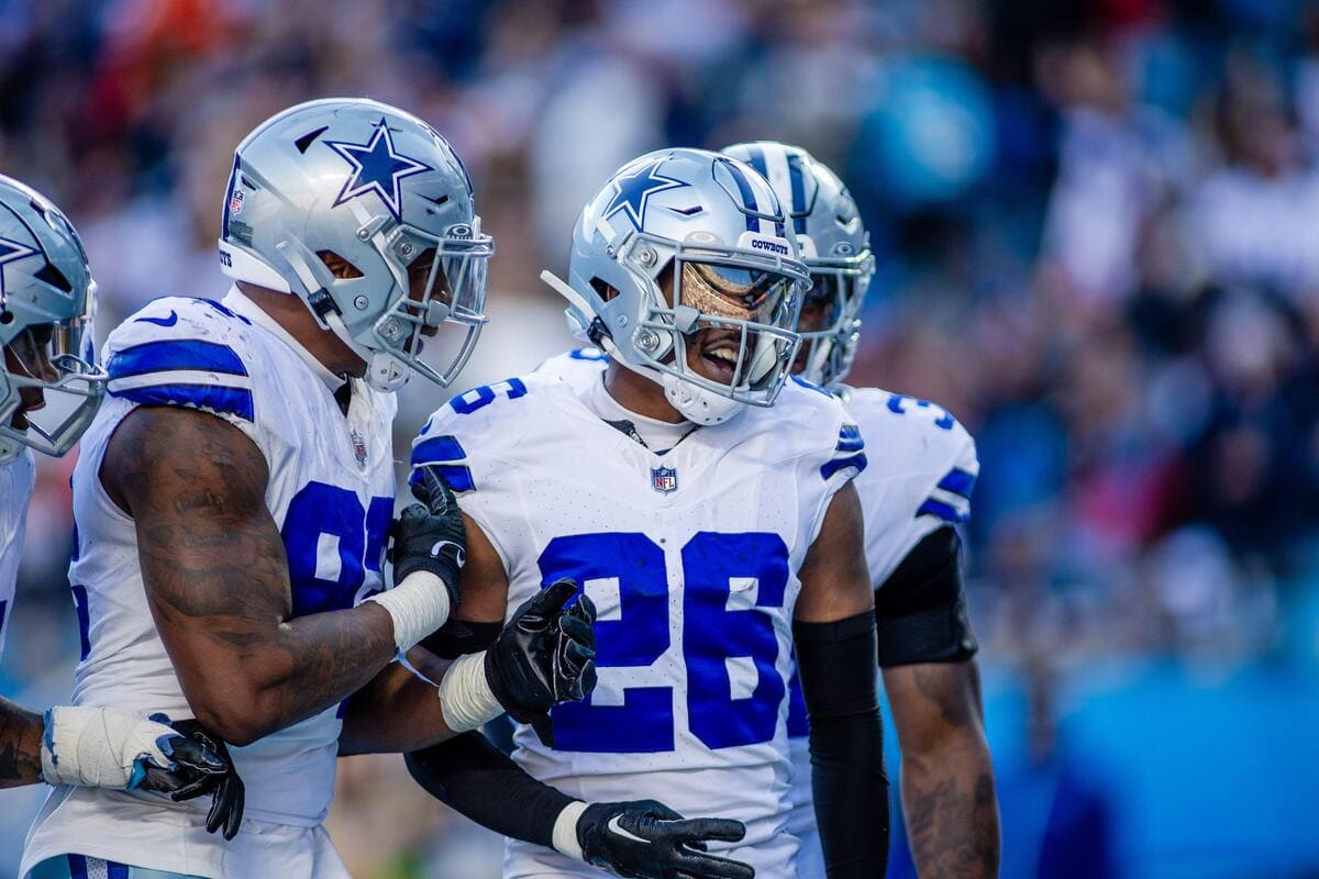 Dallas Cowboys cornerback Da'Ron Bland celebrates an interception with teammates.