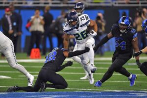 Seattle Seahawks running back Zach Charbonnet trying to avoid a tackle.