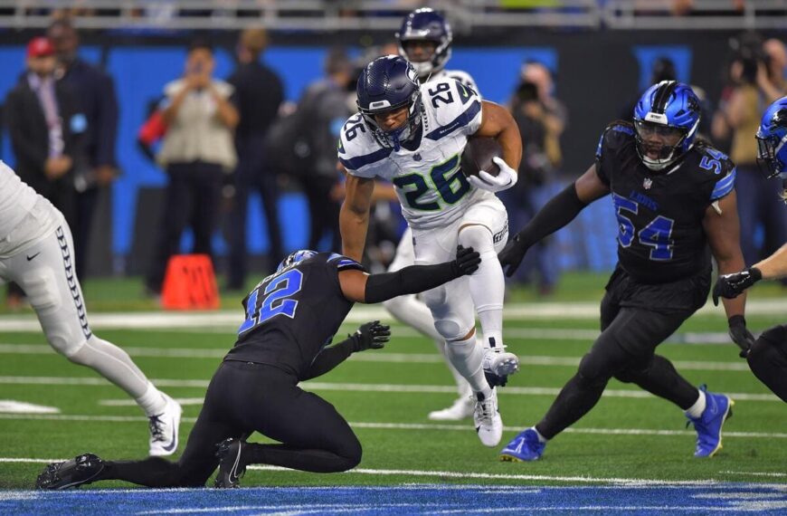 Seattle Seahawks running back Zach Charbonnet trying to avoid a tackle.