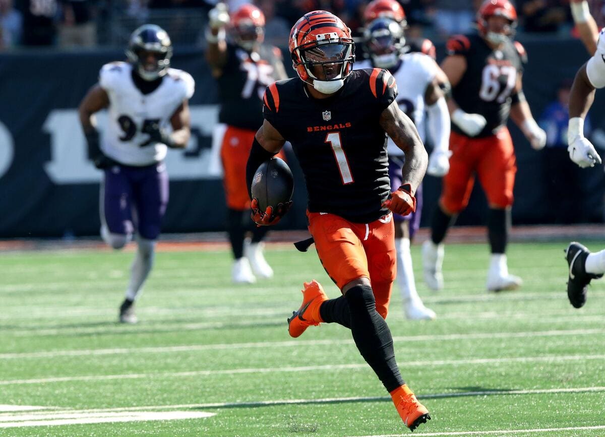 Cincinnati Bengals wide receiver Ja'Marr Chase running with a football.