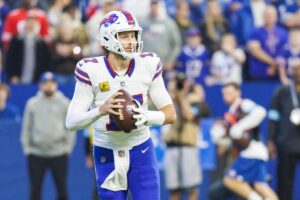 Buffalo Bills quarterback Josh Allen dropping back with a football in his hands.