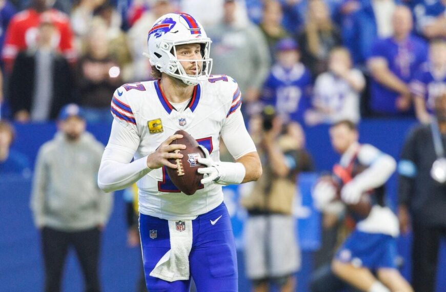 Buffalo Bills quarterback Josh Allen dropping back with a football in his hands.