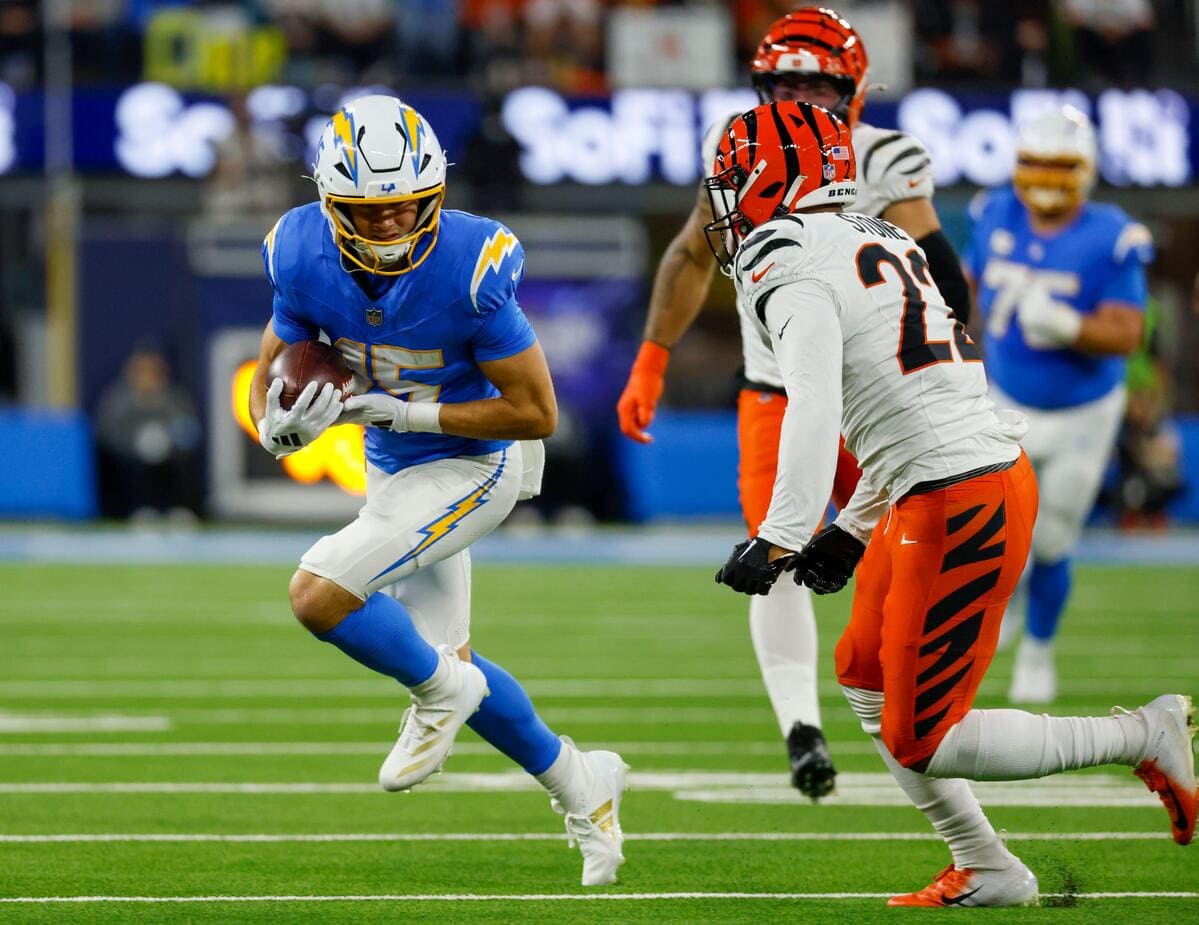 Los Angeles Chargers wide receiver Ladd McConkey running with a football while eyeing a defender.