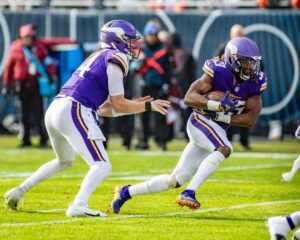 Minnesoat Vikings running back Aaron Jones takes a hand-off from quarterback Sam Darnold.