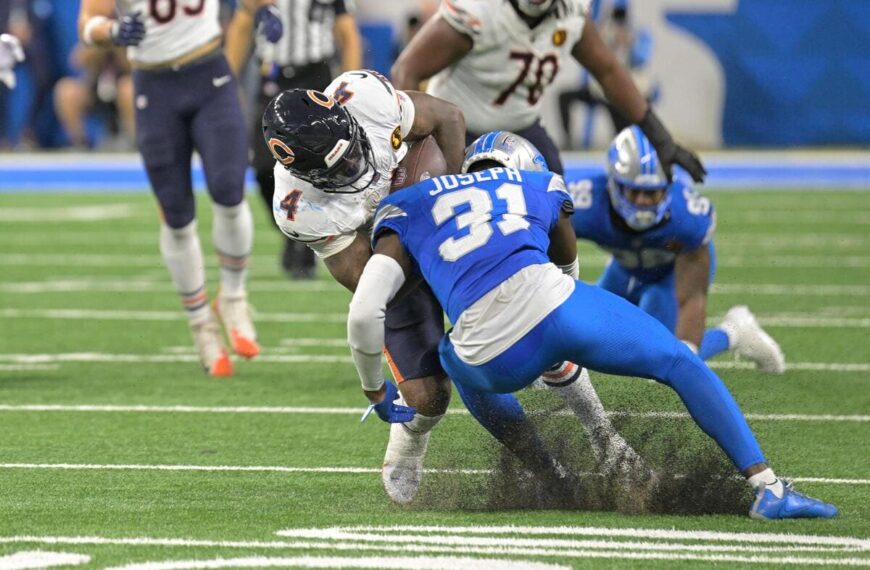 Detroit Lions defensive back Kerby Joseph tackles an opposing player.