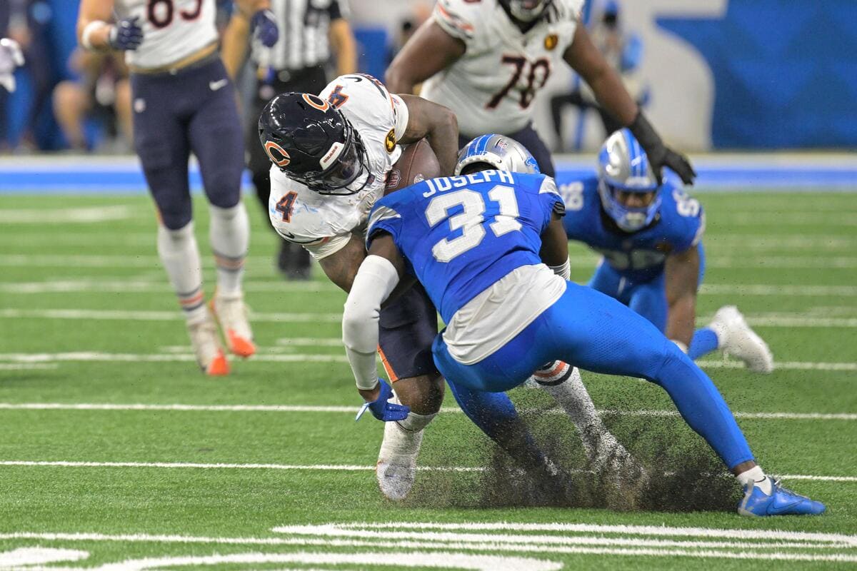 Detroit Lions defensive back Kerby Joseph tackles an opposing player.