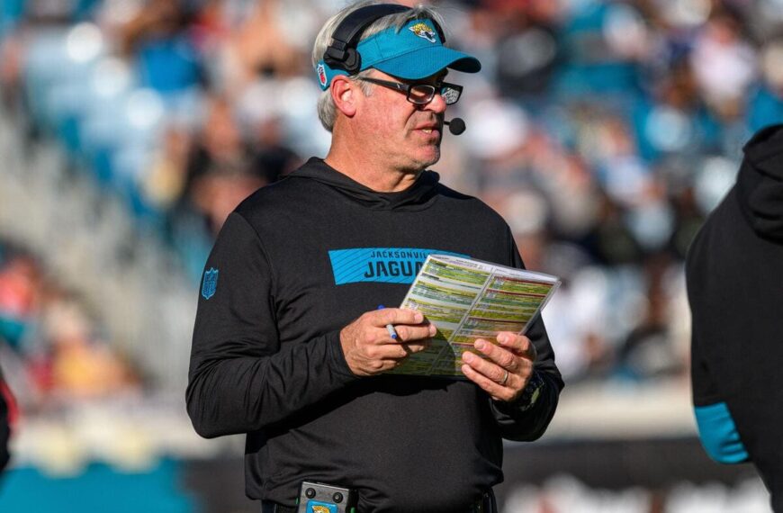 Jacksonville Jaguars head coach Doug Pederson holding a playsheet.