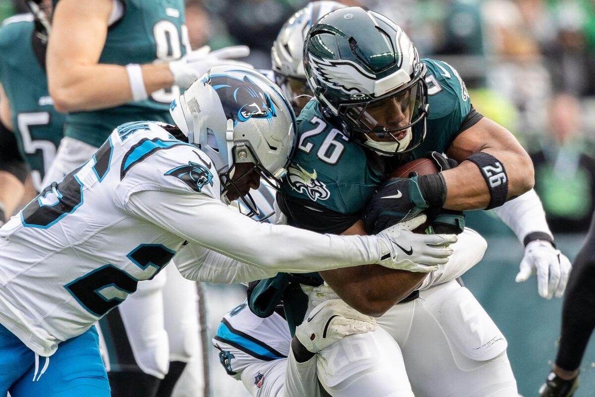 Running back Saquon Barkley being tackled by a Carolina Panthers defender.