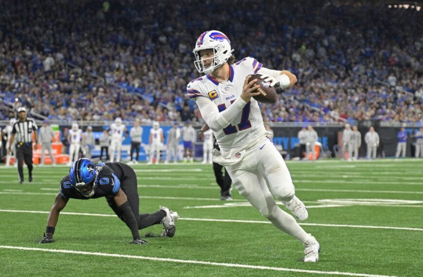 Buffalo Bills quarterback Josh Allen running with a football.