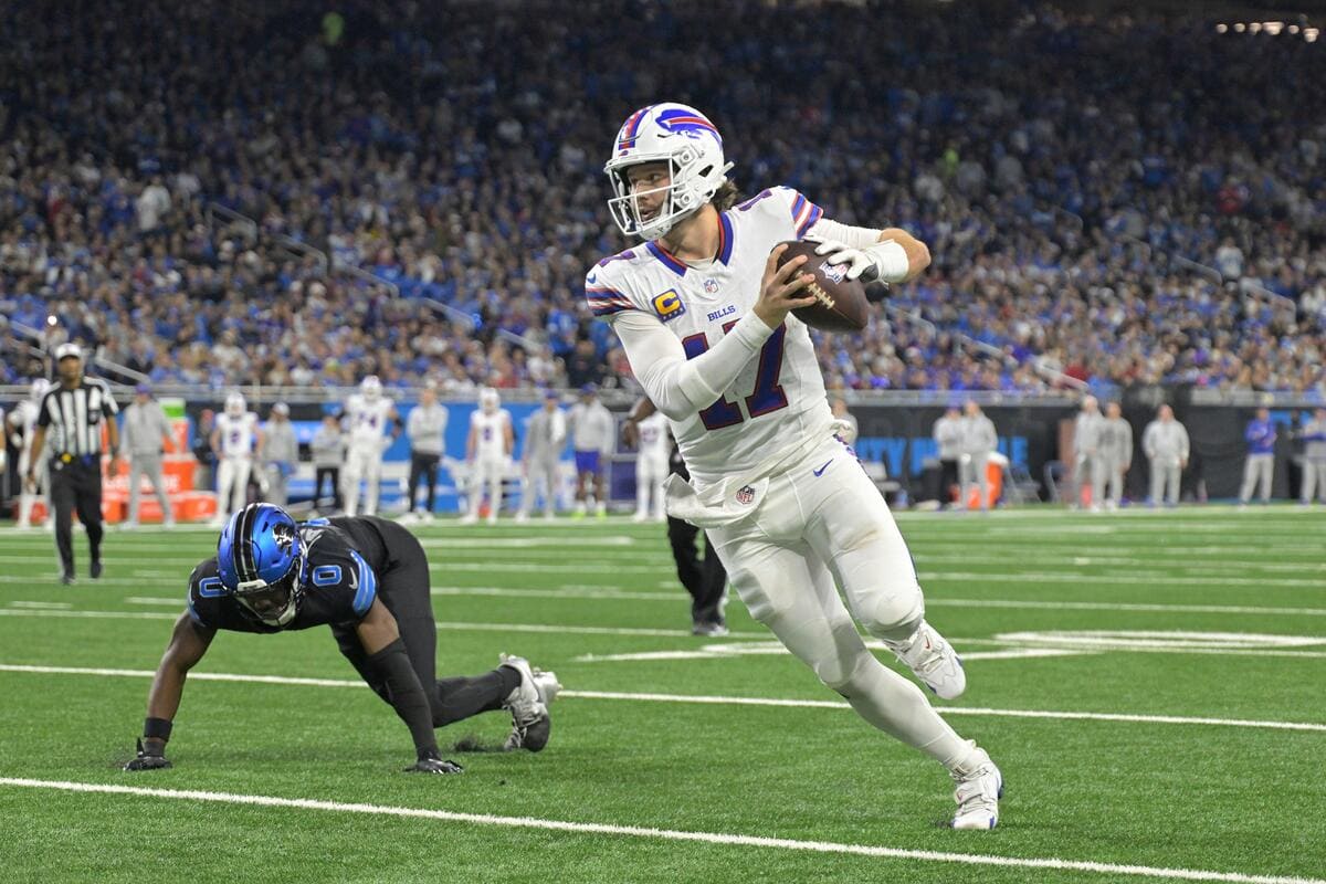 Buffalo Bills quarterback Josh Allen running with a football.