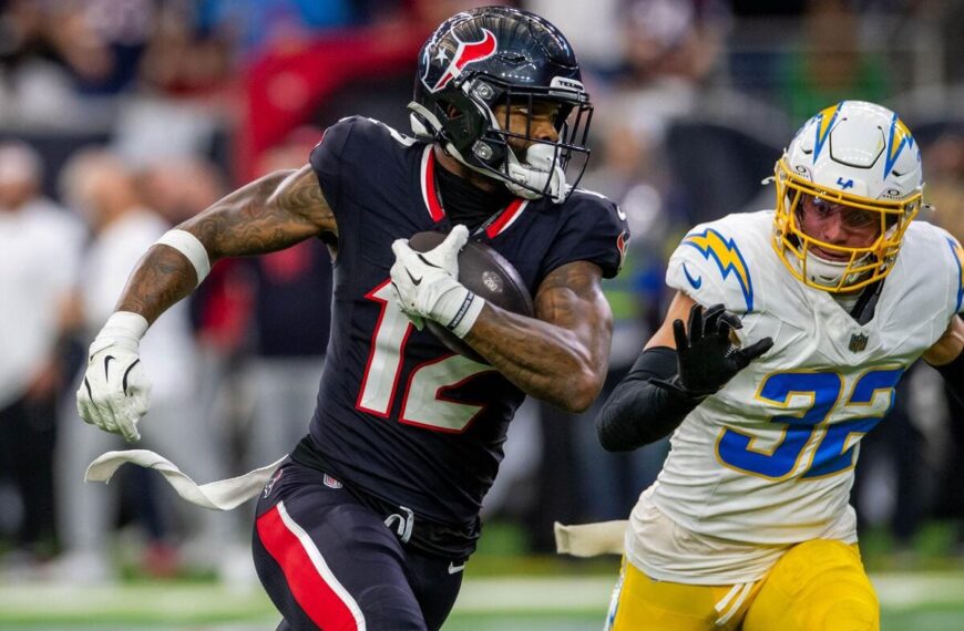 Houston Texans wide receiver Nico Collins runs away from a defender.