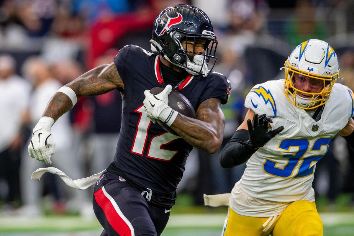 Houston Texans wide receiver Nico Collins runs away from a defender.