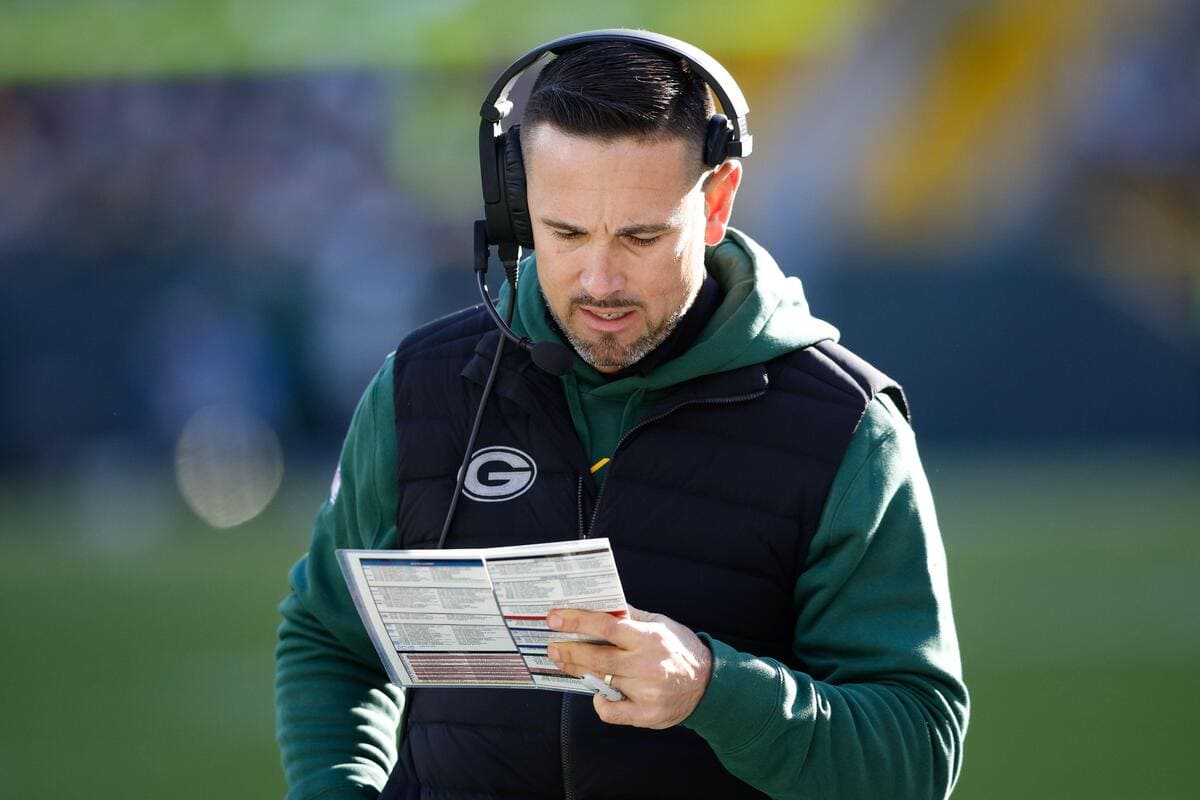 Green Bay Packers head coach Matt LaFleur looks at a play sheet.