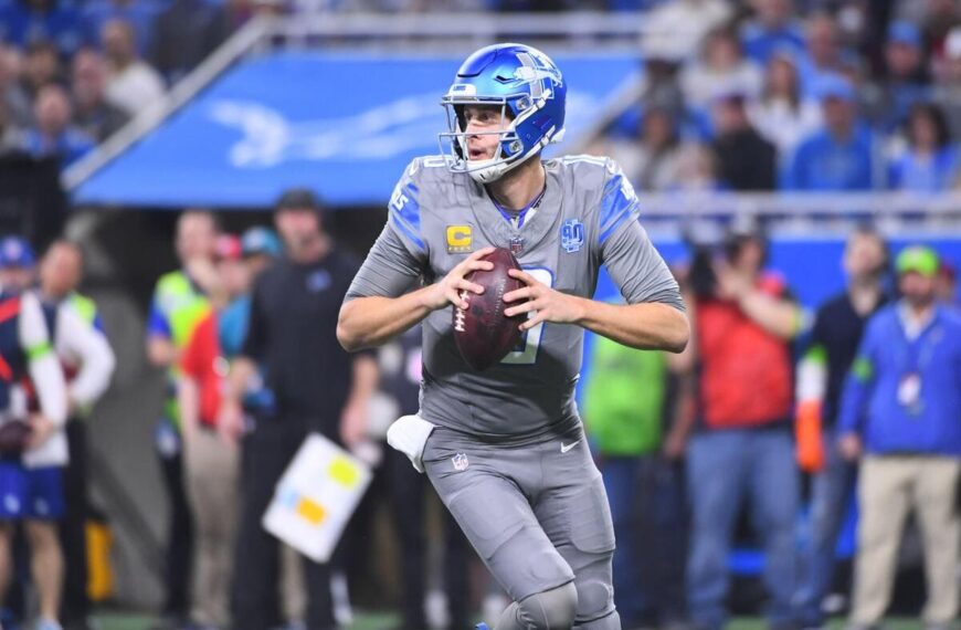 Detroit Lions quarterback Jared Goff runs with a football.