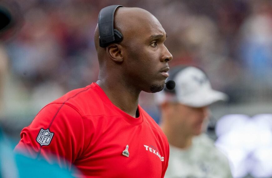 Houston Texans head coach DeMeco Ryans looks at a football field.