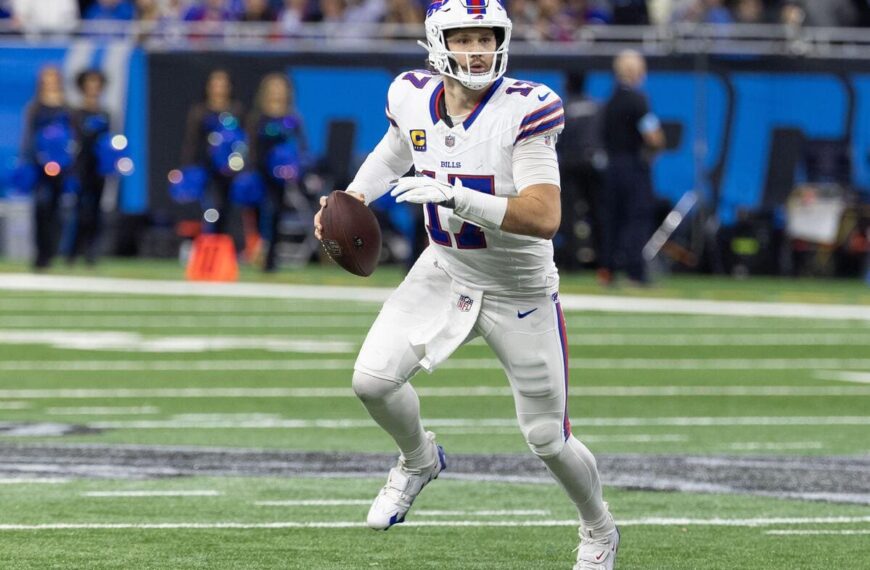 Buffalo Bills quarterback Josh Allen looks downfield while holding a football.