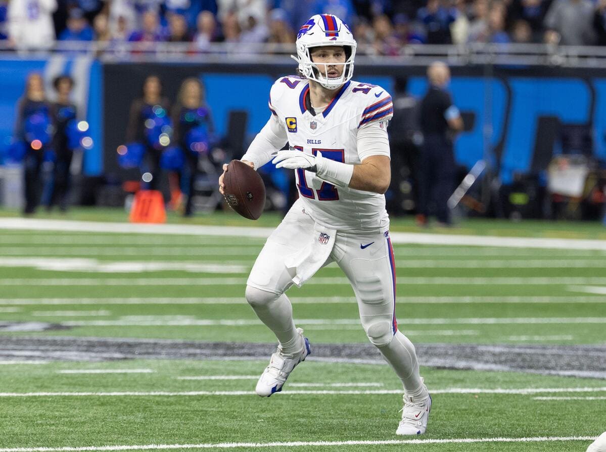 Buffalo Bills quarterback Josh Allen looks downfield while holding a football.