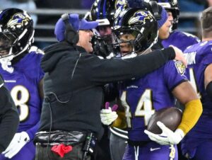 Baltimore Ravens head coach John Harbaugh celebrates with defensive back Marlon Humphrey