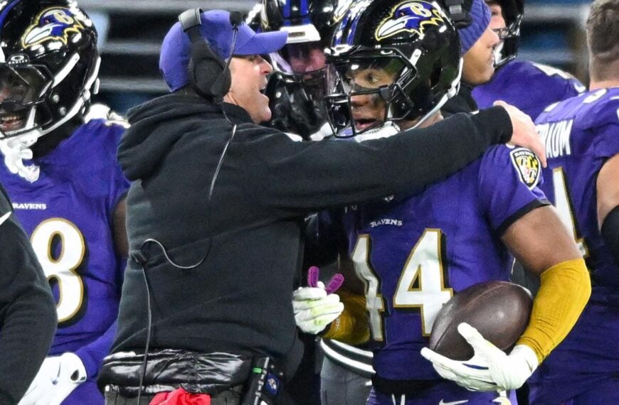 Baltimore Ravens head coach John Harbaugh celebrates with defensive back Marlon Humphrey